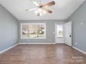 Bright living room featuring hardwood floors, vaulted ceilings and a ceiling fan at 5136 Wheat Sw Dr, Concord, NC 28027
