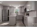 Modern kitchen featuring gray cabinets, marble countertops, and stainless steel appliances at 7704 Cedar Bluff Ln, Charlotte, NC 28227