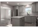 Renovated kitchen with gray cabinets, a large island, and stainless steel appliances at 7704 Cedar Bluff Ln, Charlotte, NC 28227