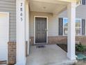 Covered front porch entryway with a dark gray door and white columns at 7865 Whispering Stream Dr, Sherrills Ford, NC 28673