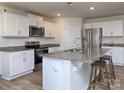 Modern kitchen with white cabinets, granite countertops, and stainless steel appliances at 7865 Whispering Stream Dr, Sherrills Ford, NC 28673