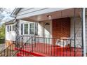 Front porch with red floor, metal railing, and a white porch swing at 1235 10Th Ne St, Hickory, NC 28601