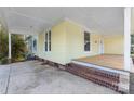 Side view of the home's front porch with brick steps and a parking area at 305 Elm St, Lancaster, SC 29720