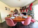 Charming dining room featuring a wood table and pink chairs, along with a Christmas tree at 507 Texas Trl, Dallas, NC 28034