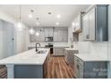 Modern kitchen with gray cabinets, quartz countertops, and an island at 14854 Tamarack Dr, Charlotte, NC 28278