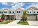 Attractive townhome community featuring two-story homes with garages at 14862 Tamarack Dr, Charlotte, NC 28278