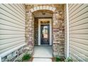 Inviting entryway with stone details and a dark brown front door at 14862 Tamarack Dr, Charlotte, NC 28278