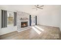 Living room with fireplace, wood-look floors, and lots of natural light at 4919 Country Oaks Dr, Rock Hill, SC 29732