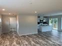 Open living space with kitchen, island, and access to deck at 51 Rosemont Dr, Stony Point, NC 28678