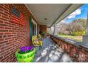 Spacious front porch with brick columns and yellow chairs at 103 2Nd Nw St, Catawba, NC 28609