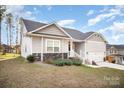 Gray siding, stone accents, and landscaping enhance curb appeal at 159 Rubys Way # 35, Oakboro, NC 28129