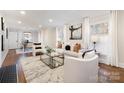 Spacious living room featuring hardwood floors, a neutral color palette, and ample natural light at 1820 Townsend Ave, Charlotte, NC 28205