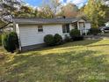 White ranch home with a grassy yard and ramp at 560 Harris Rd, Salisbury, NC 28147