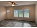 Bright living room featuring vinyl plank flooring and ceiling fan at 568 Drumstand Rd, Stony Point, NC 28678