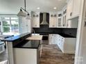 Modern kitchen with white cabinets, stainless steel appliances, and a large island at 698 Lake Head Rd, Norwood, NC 28128