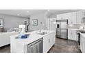 Modern kitchen featuring white cabinets, stainless steel appliances, and an island at 7315 Childress Sw Dr, Concord, NC 28025
