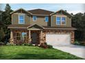 Two-story house with stone and shingle accents, a two-car garage, and landscaping at 108 Sentinel Ct, Mooresville, NC 28115