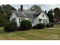 Side view of a white house with green landscaping at 1716 3Rd Ne St, Hickory, NC 28601