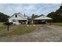 Front view of a house with carport and landscaping at 1716 3Rd Ne St, Hickory, NC 28601