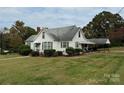 White house with carport and spacious yard at 1716 3Rd Ne St, Hickory, NC 28601
