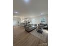 Open living room and kitchen with light hardwood floors and modern light fixtures at 508 S Boyd St, Gastonia, NC 28052