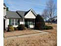 Attractive exterior, showcasing a well-maintained tan home and landscaping at 7374 Sun Dance Dr, Fort Mill, SC 29707