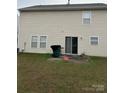 Home's backyard with a patio, grassy area, and a wooden fence at 4720 Meadowfield Rd # 38, Charlotte, NC 28215