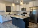 Modern kitchen with stainless steel appliances and an island at 533 Copes Ct, Kannapolis, NC 28081