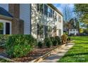 House exterior showcasing landscaping, walkway, and side yard at 11716 Buckstone Ln, Charlotte, NC 28277