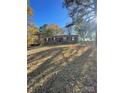 Brick ranch home with a large front yard and mature trees at 48844 Hidden Rd, Norwood, NC 28128