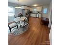 Bright kitchen with white cabinets, stainless steel appliances, and laminate flooring at 48844 Hidden Rd, Norwood, NC 28128