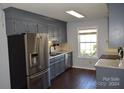 Kitchen boasts gray cabinets, stainless steel appliances, and granite countertops at 1091 Farm Pond Ln, Rock Hill, SC 29732