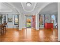 Two-story foyer with hardwood floors and a view to the front door at 157 Montibello Dr, Mooresville, NC 28117