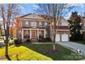 Two-story home with brick facade, red roof, and attached two-car garage at 157 Montibello Dr, Mooresville, NC 28117