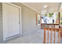 Front porch with white door and wood railing at 403 N Ransom St, Gastonia, NC 28052