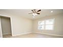 Living room with light walls, ceiling fan, and hardwood floors at 403 N Ransom St, Gastonia, NC 28052