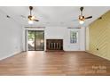 Living room with fireplace, sliding doors, and laminate flooring at 9711 Covedale Dr, Charlotte, NC 28270