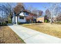 Two story house with driveway and landscaping. Sunny autumn day at 6309 Spring Garden Ln, Charlotte, NC 28213