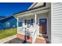 Inviting front porch with brick steps and white railing at 213 E Madison St, York, SC 29745