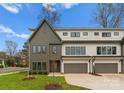 Modern two-story townhome with gray and white exterior, two-car garage, and landscaped lawn at 2911 Hilliard Dr, Charlotte, NC 28205