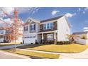 A two-story home with gray and stone siding, white garage, and front yard landscaping at 7607 Nolen Farm Dr, Gastonia, NC 28056