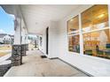 Inviting front porch with stone pillars and view of neighborhood at 2015 Cedar Falls Dr # 72, Waxhaw, NC 28173
