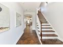 Bright entryway with hardwood floors, staircase, and artwork at 110 Mint Ave # C, Mooresville, NC 28117