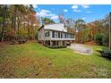 Back of house showing a sunroom and patio, surrounded by trees at 533 Amanda Dr, Matthews, NC 28104