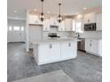 White kitchen with large island, granite countertops, and gray tile floor at Lot 41 Watercourse Way # Savanh, Belmont, NC 28012