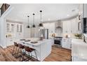 Modern kitchen with white cabinets, stainless steel appliances, and an island at Lot 41 Watercourse Way # Savanh, Belmont, NC 28012