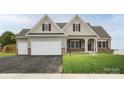 Ranch-style home with maroon accents and a two-car garage at Lot 51 Watercourse Way # Arcadia, Belmont, NC 28012