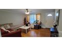 Living room with hardwood floors, large windows, and a cozy seating area at 110 E Buckoak St, Stanley, NC 28164