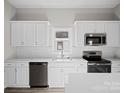 Modern kitchen with white cabinets, stainless steel appliances, and white subway tile at 3332 York Hwy, Gastonia, NC 28052