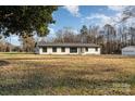 White brick ranch home with dark windows, situated on a large lot at 3700 Pinecrest Dr, Gastonia, NC 28056